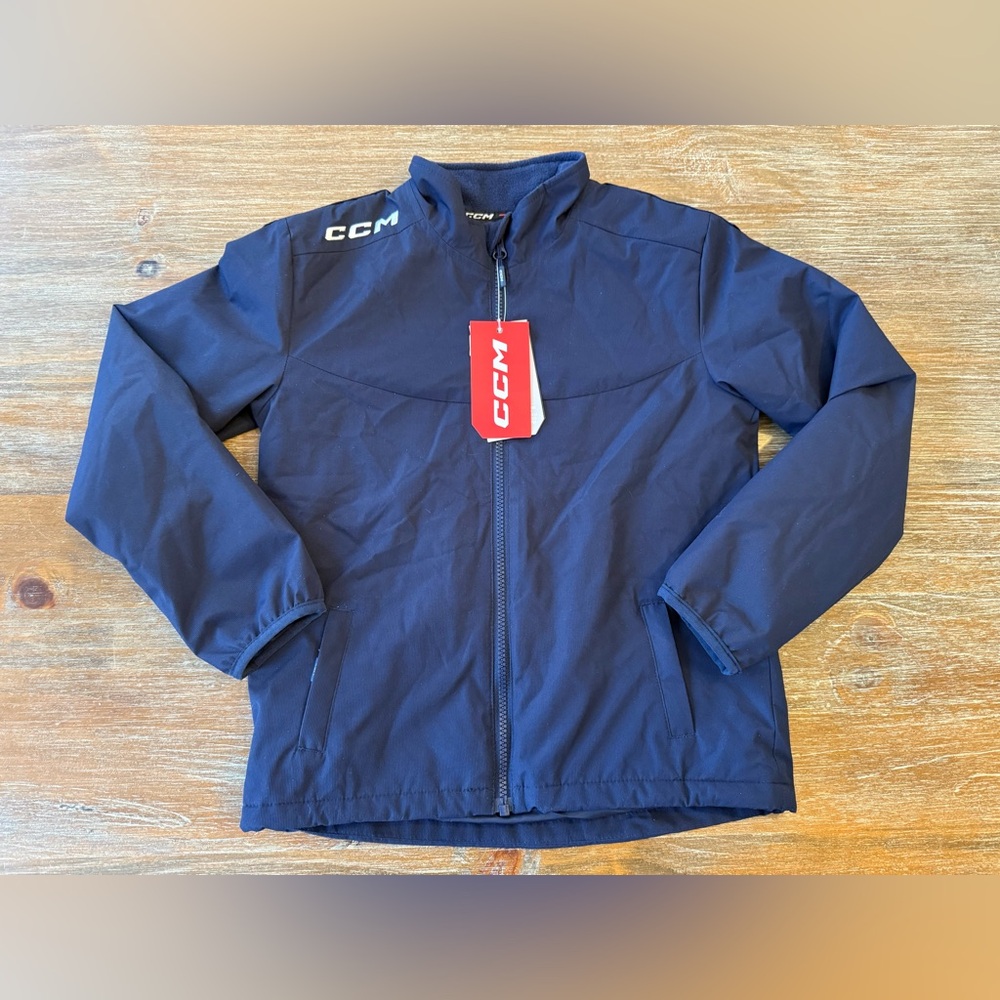 NWT YOUTH CCM NAVY MIDWEIGHT HOCKEY JACKET, SIZE SML